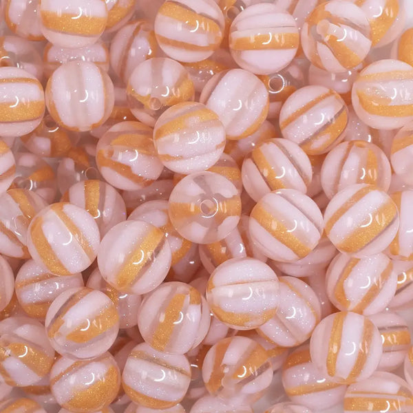 close up view of a pile of 12mm Pink Cats Eye Acrylic Bubblegum Beads - 20 Count