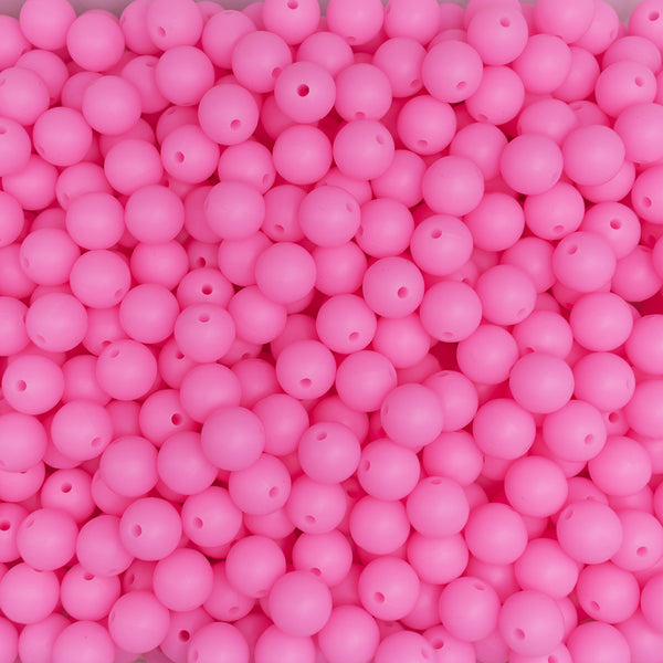 top view of a pile of 12mm Pink Glow In The Dark Silicone Bead