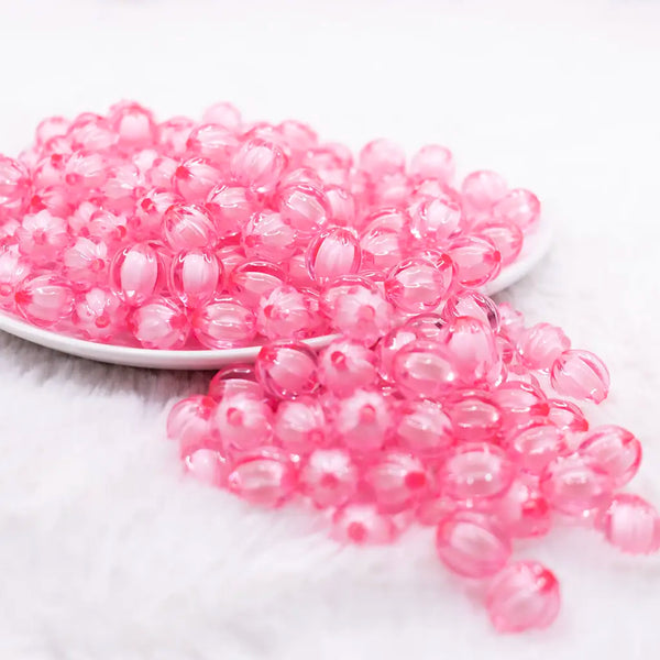 front view of a pile of 12mm Pink Transparent Pumpkin Shaped Bubblegum Beads