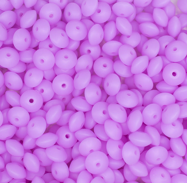 top view of a pile of 12mm Purple Glow in The Dark Lentil Silicone Bead