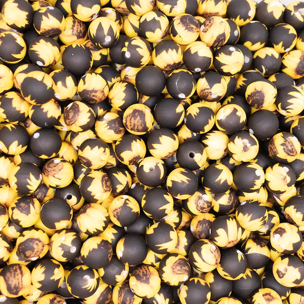 top view of a pile of 12mm Sunflower on Black Round Silicone Bead