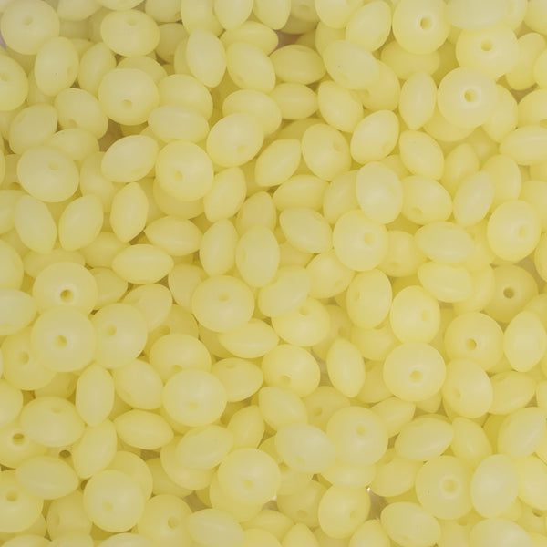top view of a pile of 12mm Yellow Glow in The Dark Lentil Silicone Bead