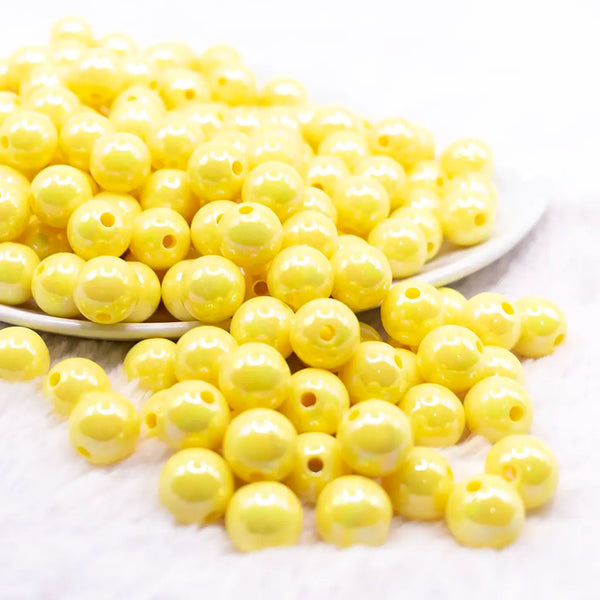 front view of a pile of 12mm Yellow AB Solid Acrylic Bubblegum Beads
