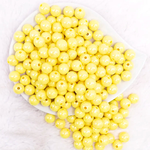 top view of a pile of 12mm Yellow AB Solid Acrylic Bubblegum Beads