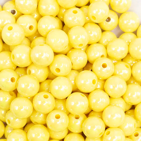 close up view of a pile of 12mm Yellow AB Solid Acrylic Bubblegum Beads