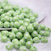 front view of a pile of 12mm Light Green with White Polka Dot Acrylic Bubblegum Beads
