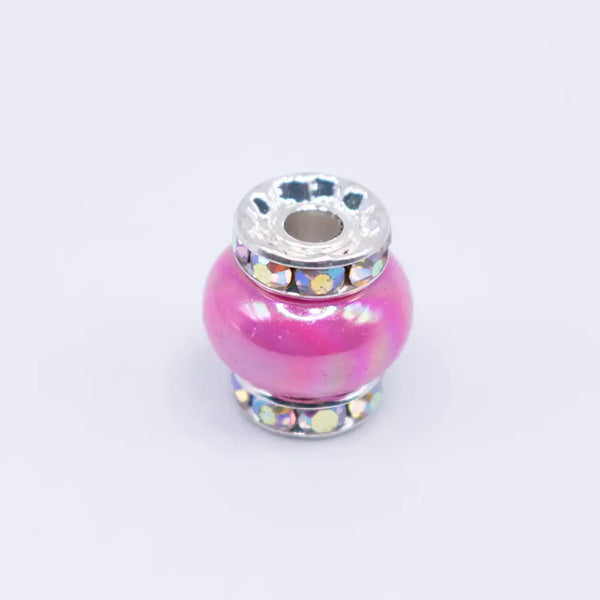 top view of a pile of 15mm Hot Pink Spacer Bead with Rhinestone Rondelle - 5 Count per order