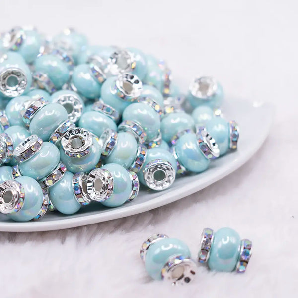 front view of a pile of 15mm Light Blue Spacer Bead with Rhinestone Rondelle - 5 Count per order