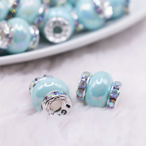 macro view of a pile of 15mm Light Blue Spacer Bead with Rhinestone Rondelle - 5 Count per order