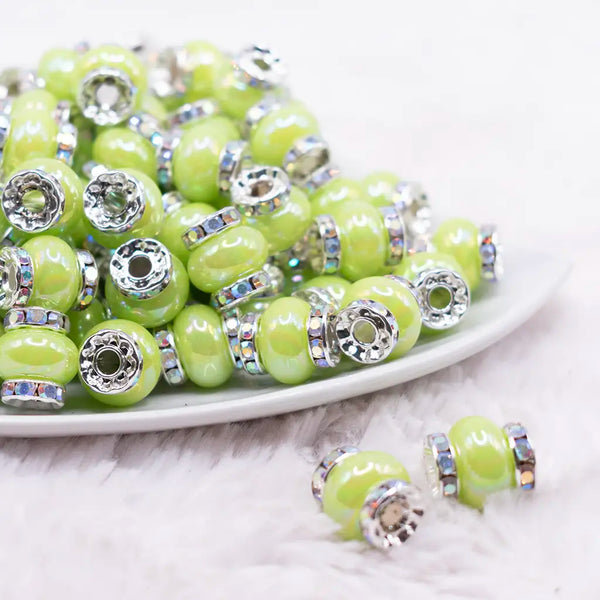 front view of a pile of 15mm Lime Green Spacer Bead with Rhinestone Rondelle - 5 Count per order