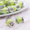 macro view of a pile of 15mm Lime Green Spacer Bead with Rhinestone Rondelle - 5 Count per order