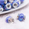 macro view of a pile of 15mm Royal Blue Spacer Bead with Rhinestone Rondelle - 5 Count per order