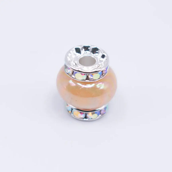 top view of a pile of 15mm Sand Spacer Bead with Rhinestone Rondelle - 5 Count per order