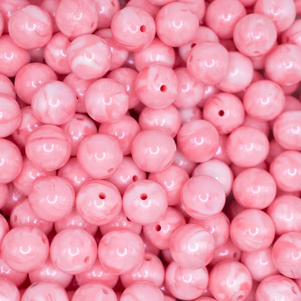 top view of a pile of 15mm Pink Marbled Opal Shimmer Round Silicone Bead