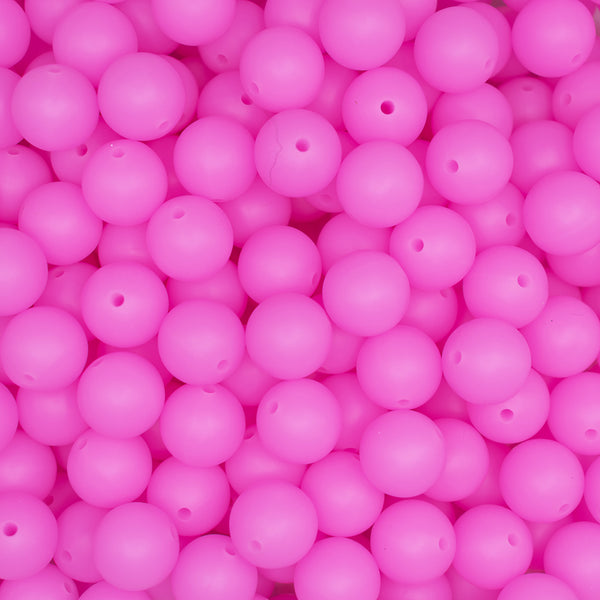 front view of a pile of 12mm Bright Pink Glow In The Dark Silicone Bead