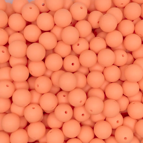 close up view of a pile of 15mm Cantelope Orange Round Silicone Bead