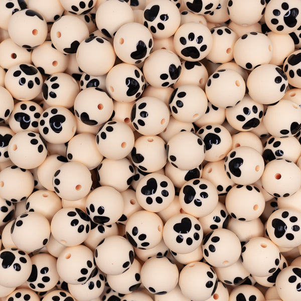 top view of a pile of 15mm Cream with Paw Print Silicone Bead