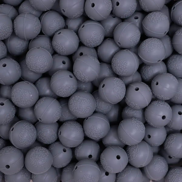 top view of a pile of 15mm Dim Gray Embossed Floral Print Silicone Bead
