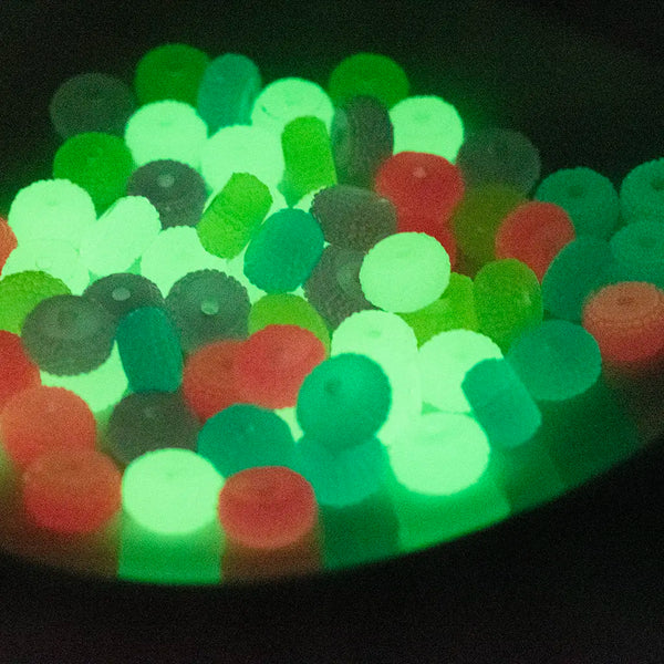 view of a pile of 12mm Yellow Glow In the Dark Resin Rondelle Spacer Beads - Set of 20