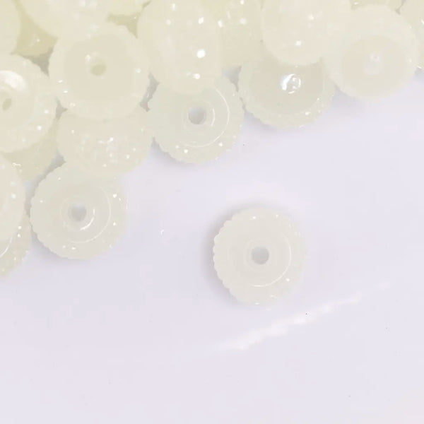 close up view of a pile of 12mm Glow In the Dark Resin Rondelle Spacer Beads - Set of 20