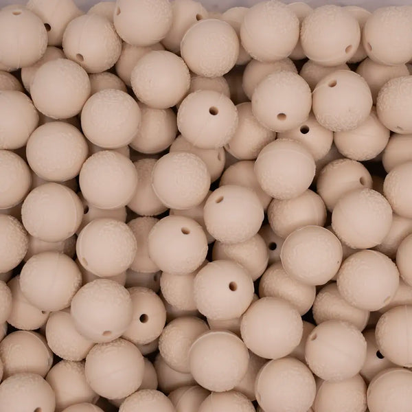 top view of a pile of 15mm Navajo White Embossed Floral Print Silicone Bead