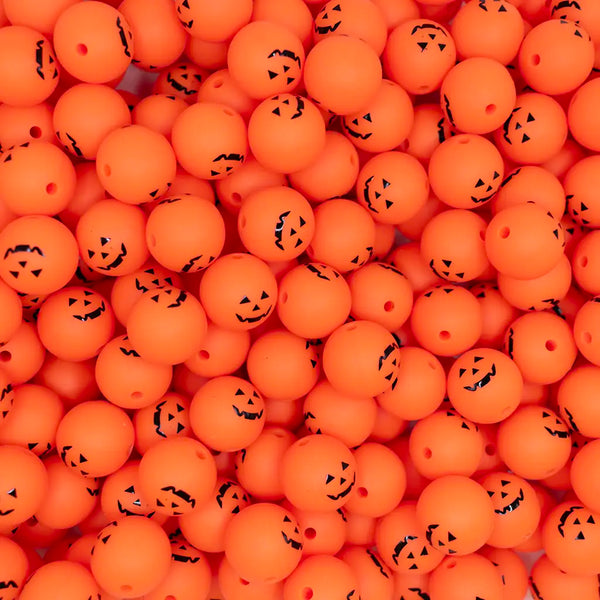 top view of a pile of 15mm Jack O Lantern Face Silicone Bead