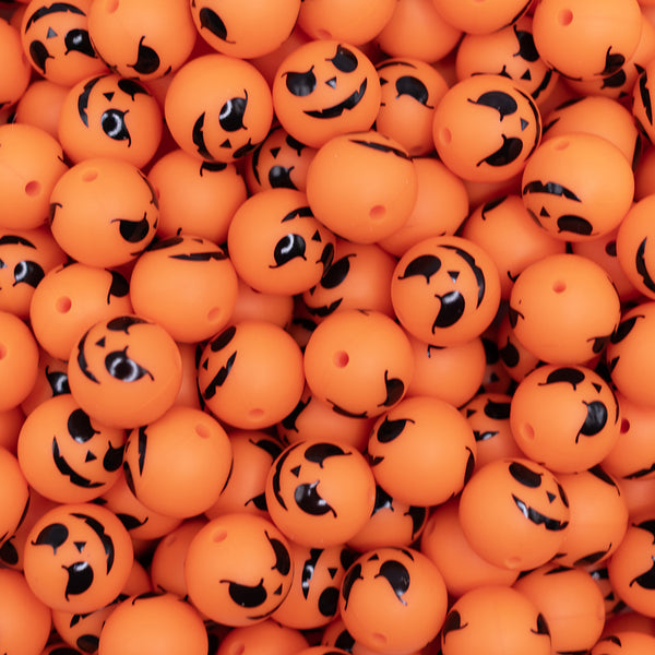 top view of a pile of 15mm Pumpkin Face Print Silicone Bead