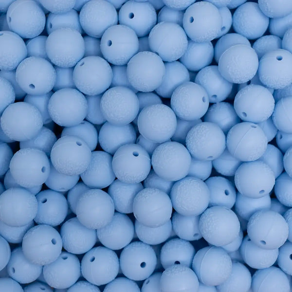 top view of a pile of 15mm Pastel Blue Embossed Floral Print Silicone Bead
