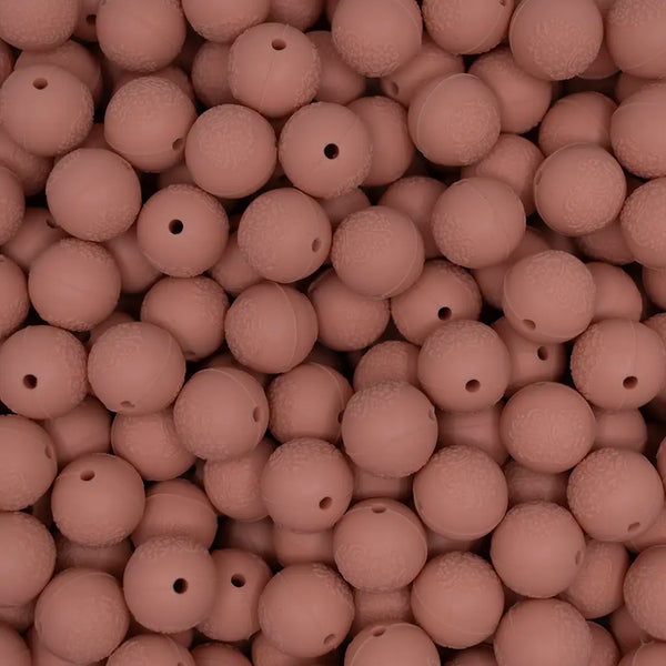 top view of a pile of 15mm Peach Embossed Floral Print Silicone Bead