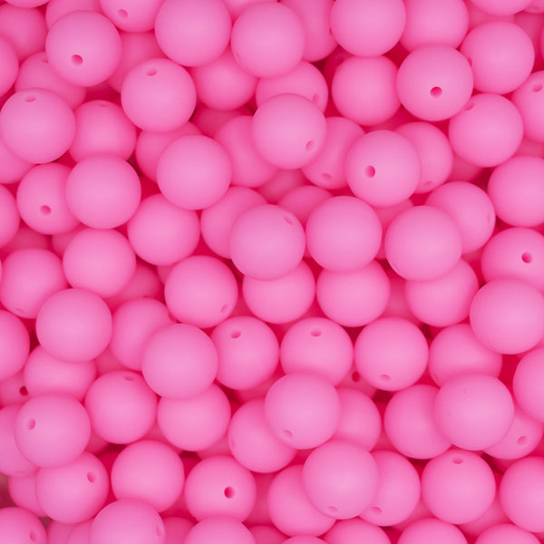 top view of a pile of 15mm Pink Glow In The Dark Silicone Bead