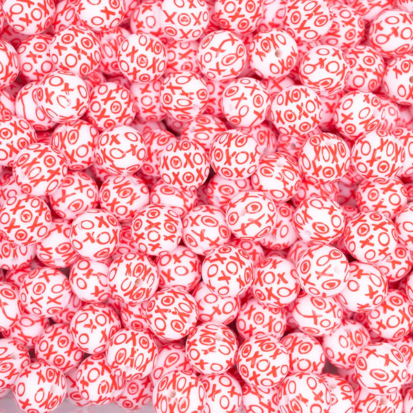 top view of a pile of 15mm Red Confetti XOXO Print Silicone Bead