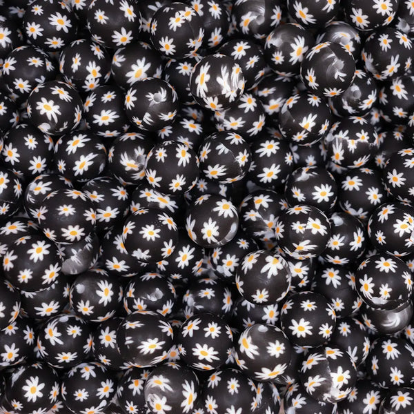 top view of a pile of 15mm White Daisy on Black Silicone Bead
