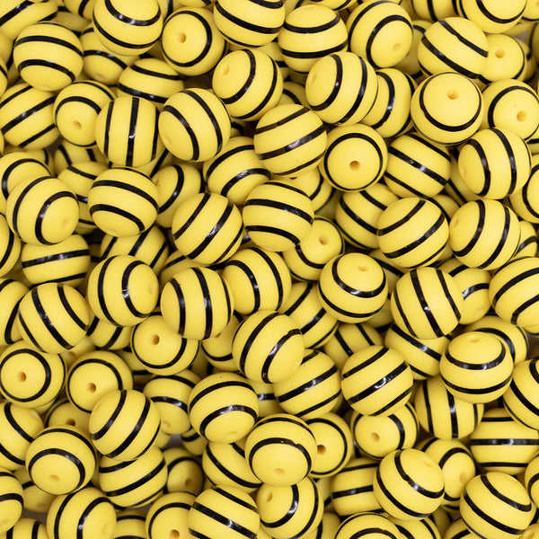 top view of a pile of 15mm Yellow with Black Stripe Silicone Bead