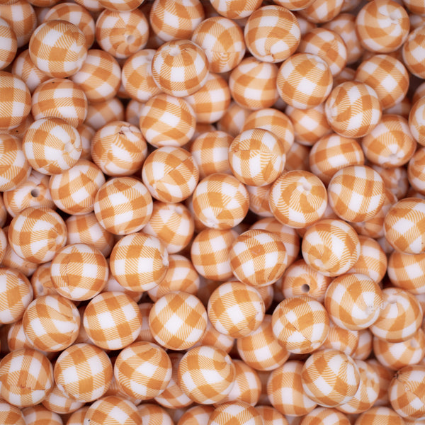top view of a pile of 15mm Orange Plaid Print Silicone Bead