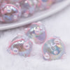 close up view of a pile of 16mm Clear with White Flower luxury acrylic beads