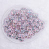 top view of a pile of 16mm Clear with White Flower luxury acrylic beads