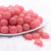 front view of a pile of 16mm Coral Pink Glitter Sparkle Bubblegum Beads