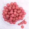 top view of a pile of 16mm Coral Pink Glitter Sparkle Bubblegum Beads