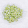 top view of a pile of 16mm Green Snowflake luxury acrylic beads