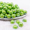 front view of a pile of 16mm Green Mean One Face AB Bubblegum Beads