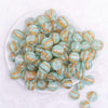 top view of a pile of 16mm Mint Green Cats Eye Acrylic Bubblegum Beads