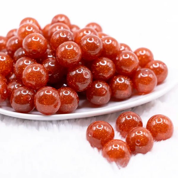 front view of a pile of 16mm Orange Glitter Sparkle Bubblegum Beads