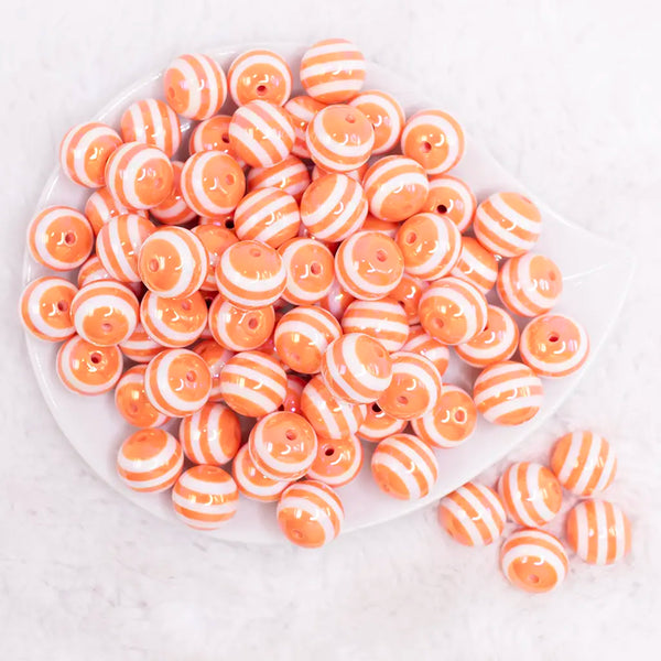 top view of a pile of 16MM Orange with AB Stripes Bubblegum Beads
