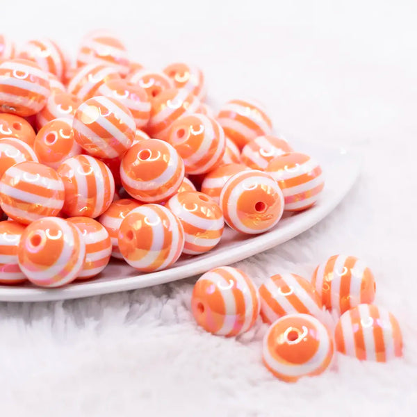 front view of a pile of 16MM Orange with AB Stripes Bubblegum Beads