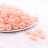 front view of a pile of 16mm Peach Crackle AB Bubblegum Beads