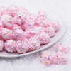 front view of a pile of 16mm Pink with Pink Flowers luxury acrylic beads