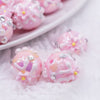 close up view of a pile of 16mm Pink with Pink Flowers luxury acrylic beads