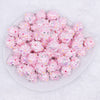 top view of a pile of 16mm Pink with Pink Flowers luxury acrylic beads
