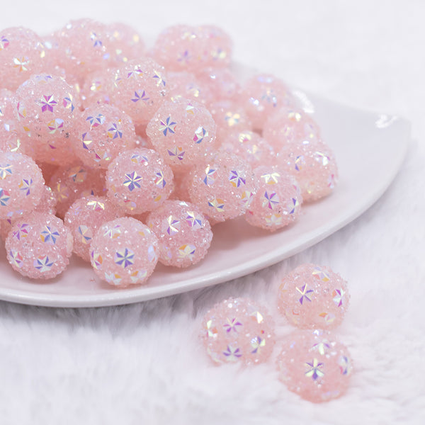 front view of a pile of 16mm Pink Snowflake luxury acrylic beads