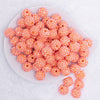 top view of a pile of 16mm Salmon Orange Rhinestone AB Bubblegum Beads